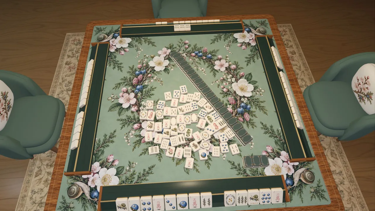 An overhead view late in a hand, with dozens of loose discards spread across the felt and the wall angled through the middle of the table.